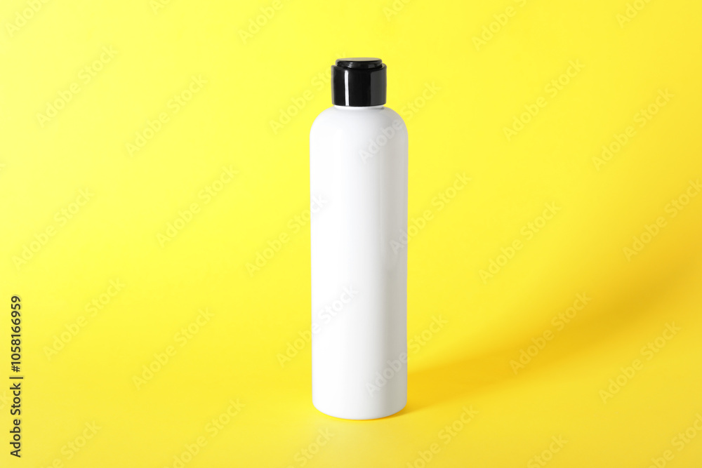 Shampoo in bottle on yellow background. Personal care product Shampoo in bottle on yellow background. Personal care product
