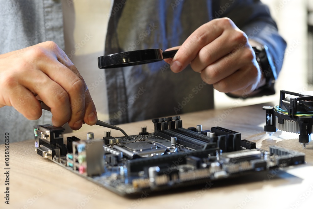 Man installing computer chip onto motherboard at wooden table, closeup Man installing computer chip onto motherboard at wooden table, closeup
