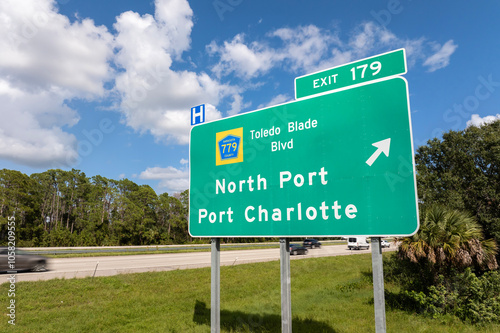 Highway interchange exit sign with direction to North Port and Port Charlotte in Florida. Interstate freeway travel in USA