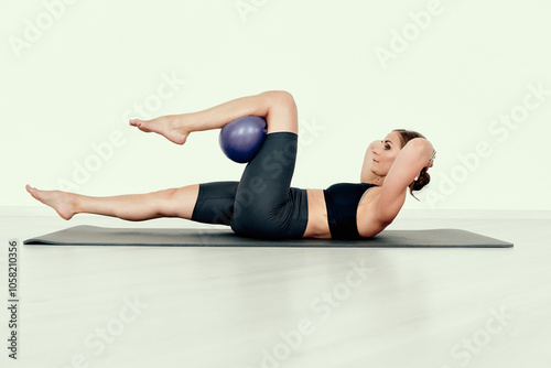 Fitness Trainer Demonstrating Bicycle Crunch with Ball
