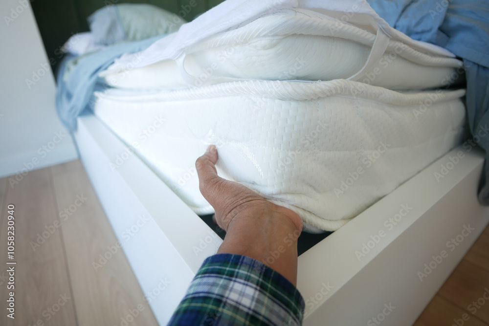 Placing the white sheet on the mattress for added comfort Placing the white sheet on the mattress for added comfort