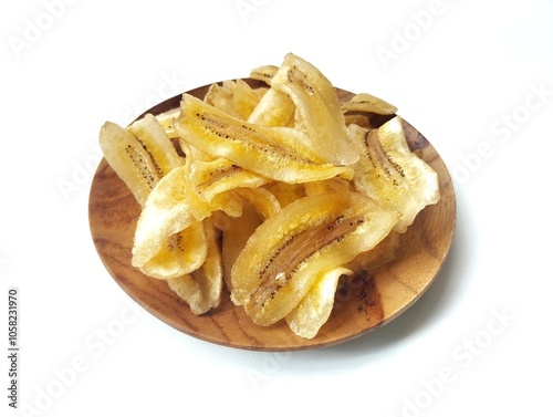 Kripik pisang or sweet banana chips on plate isolated on white background with high angle view setup  photo