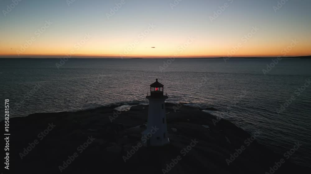 Gorgeous Cinematic Aerial View Of Peggys Cove Lighthouse On A Rocky Shore At Sunset, Highlighting The Beauty Of The Atlantic Ocean And The Nova Scotia Coastline. Gorgeous Cinematic Aerial View Of Peggys Cove Lighthouse On A Rocky Shore At Sunset, Highlighting The Beauty Of The Atlantic Ocean And The Nova Scotia Coastline.