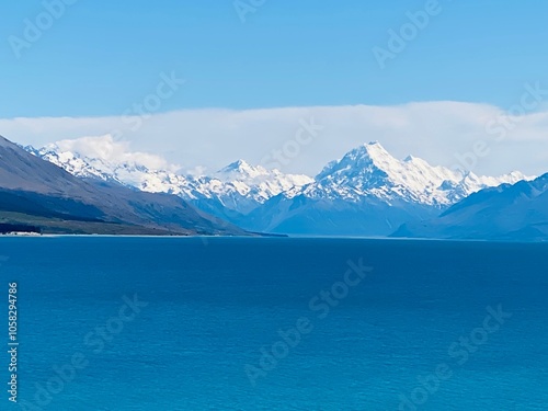 Deep blue colour of lake Pukaki with Mount Cook covered by snow at the background 