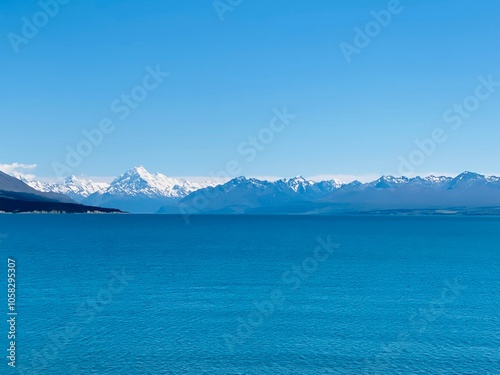 Deep blue colour of lake Pukaki with Mount Cook covered by snow at the background 