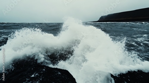 dark stormy ocean with huge waves crashing against the rocks; related to power, resilience and nature. photo