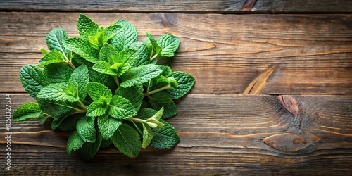 Aerial view of mint plant bunch and leaf on wooden table