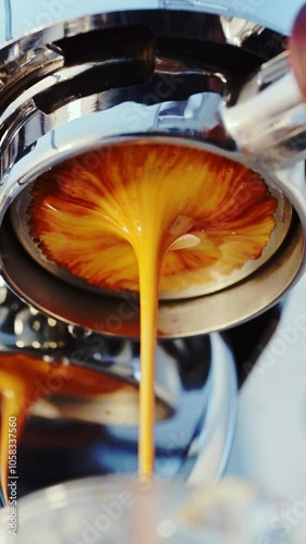 4K Pouring coffee stream from professional machine in cup. Barista man making double espresso, using filter holder. Flowing fresh ground coffee. Drinking roasted black coffee in the morning
