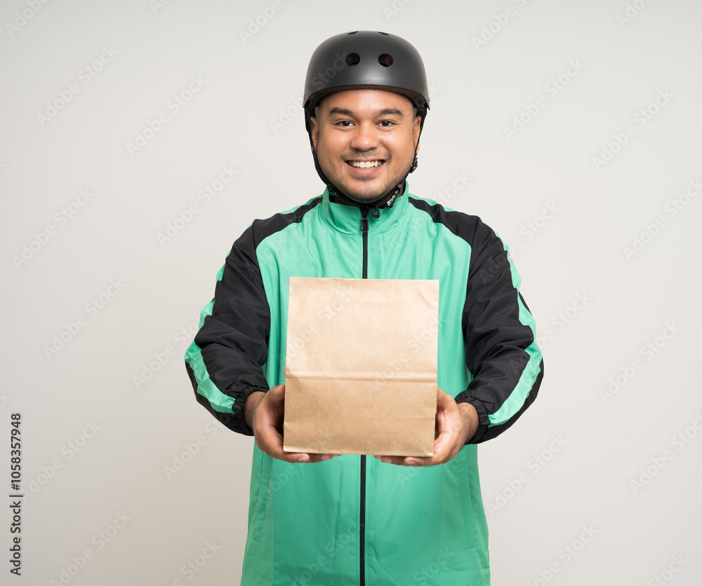 Young asian rider wearing green jacket uniform and bike helmet various action holding food paper bag delivery to customer. Male delivery service worker. Courier and shipping food service. Young asian rider wearing green jacket uniform and bike helmet various action holding food paper bag delivery to customer. Male delivery service worker. Courier and shipping food service.