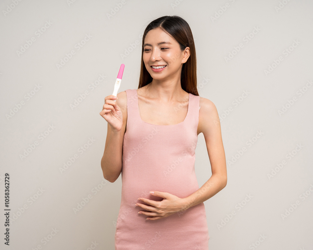Happy Pregnant asian woman stroking touch belly motherhood with pregnancy test on isolated background. Family planning maternity and pregnancy health. Happy Pregnant asian woman stroking touch belly motherhood with pregnancy test on isolated background. Family planning maternity and pregnancy health.