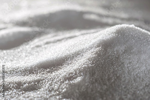 A close-up reveals a silky powder with shimmering fine granules illuminated by soft studio lighting. photo