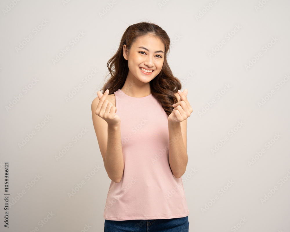 Pretty Young beautiful Asian woman standing and smiling showing mini heart sign on isolated white background. Lovely Latin female wearing pink shirt feeling surprised and happy. Pretty Young beautiful Asian woman standing and smiling showing mini heart sign on isolated white background. Lovely Latin female wearing pink shirt feeling surprised and happy.