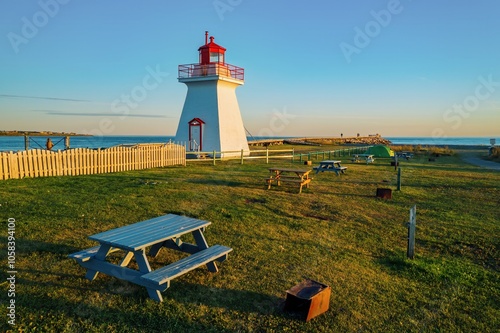 campground, picnic tables and Phare de la pointe Bonaventure lighthouse, Bonaventure, Quebec, Canada. photo