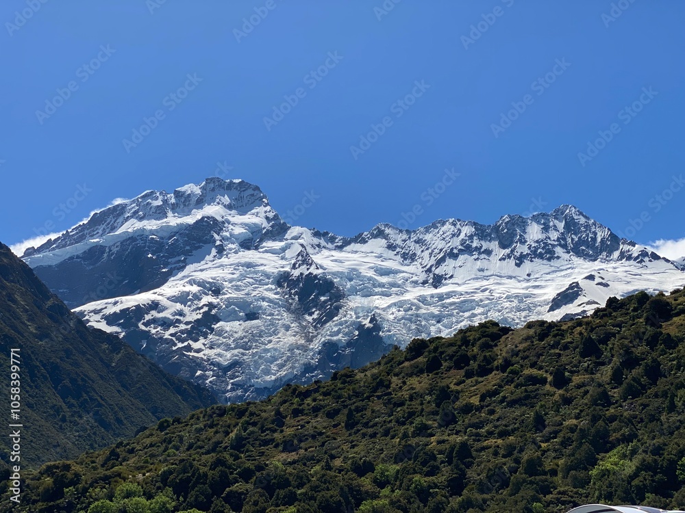 Snow capped peaks of Mount Cook and blue sky with clouds , Mount Cook National Park, New Zealand Snow capped peaks of Mount Cook and blue sky with clouds , Mount Cook National Park, New Zealand