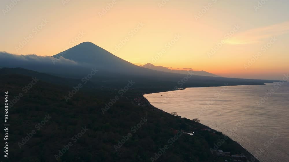 Coastline with volcano mountain and bright sunset sky in Amed, Bali. Drone view Coastline with volcano mountain and bright sunset sky in Amed, Bali. Drone view