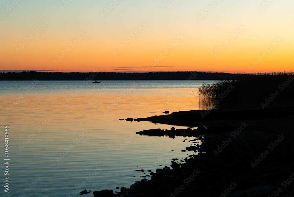 Fototapeta premium Beautiful early autumn sunrise at the lakeside in Latvia. Seasonal scenery of Northern Europe.