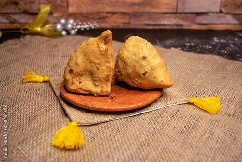 vegetable singara served in plate isolated on dark background side view of bangladeshi fast food photo