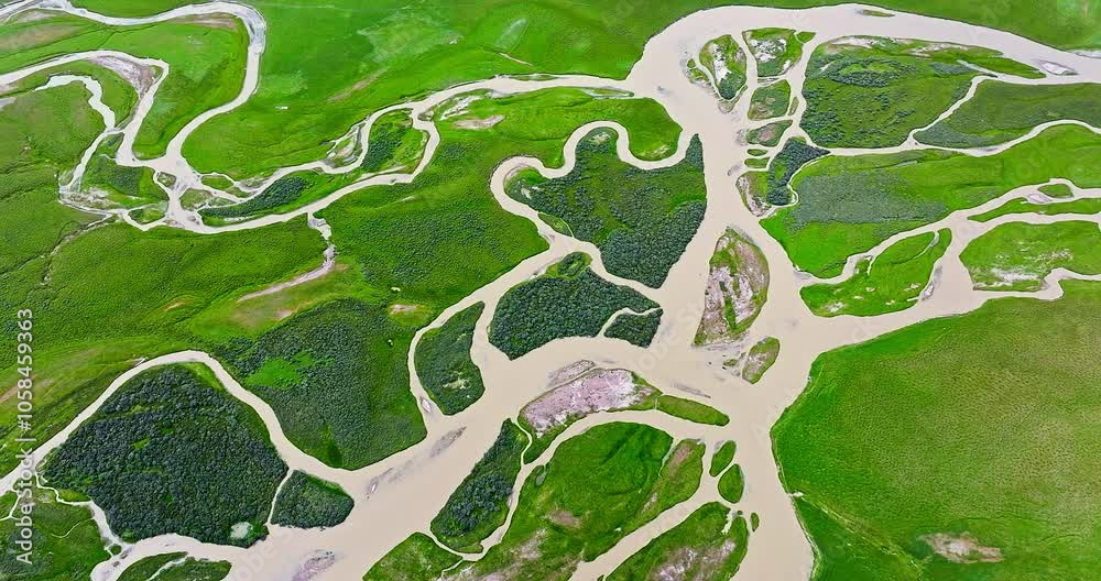 Green grassland and curved river natural landscape in Xinjiang. Famous grassland pasture scenery in China. Top view. Green grassland and curved river natural landscape in Xinjiang. Famous grassland pasture scenery in China. Top view.