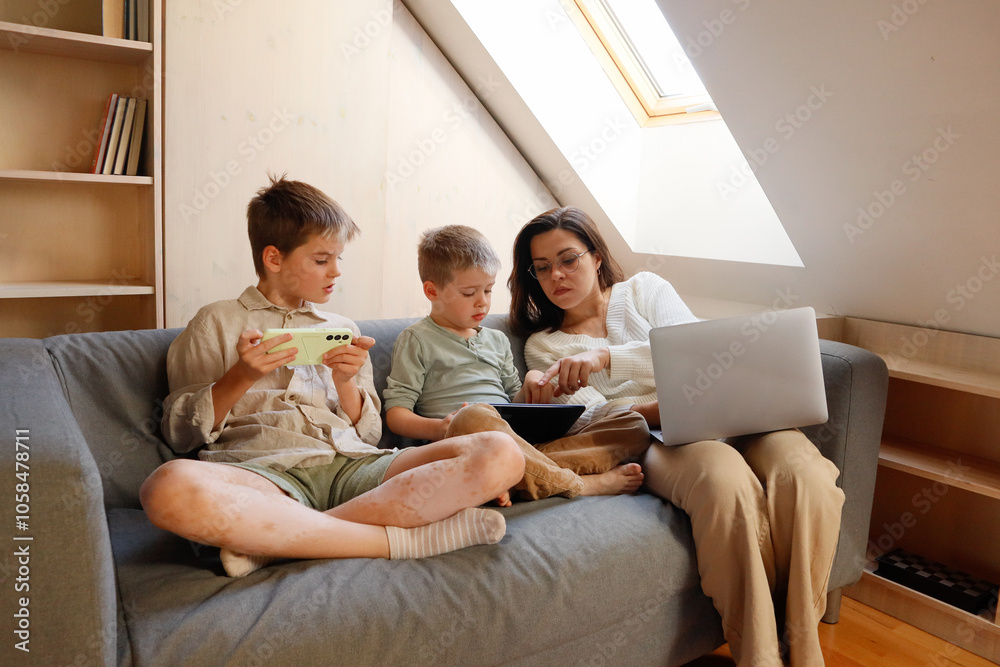 Two brothers and mother with smartphone and laptop Two brothers and mother with smartphone and laptop