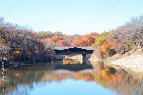 Picturesque Covered Bridge with Vibrant Autumn Foliage Reflecting in a Serene River