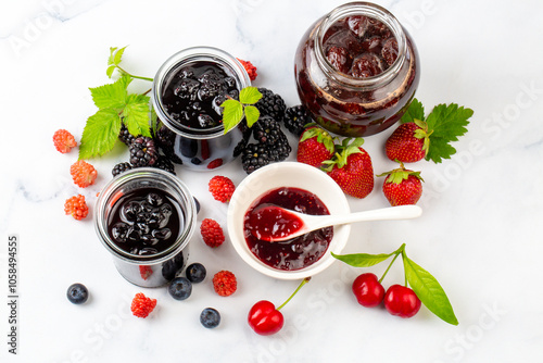 Fresh berries and jar of a ...
