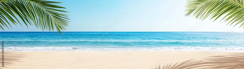 Obraz premium A serene beach scene with calm turquoise waters and lush palm leaves framing the view, perfect for relaxation and tropical ambiance.