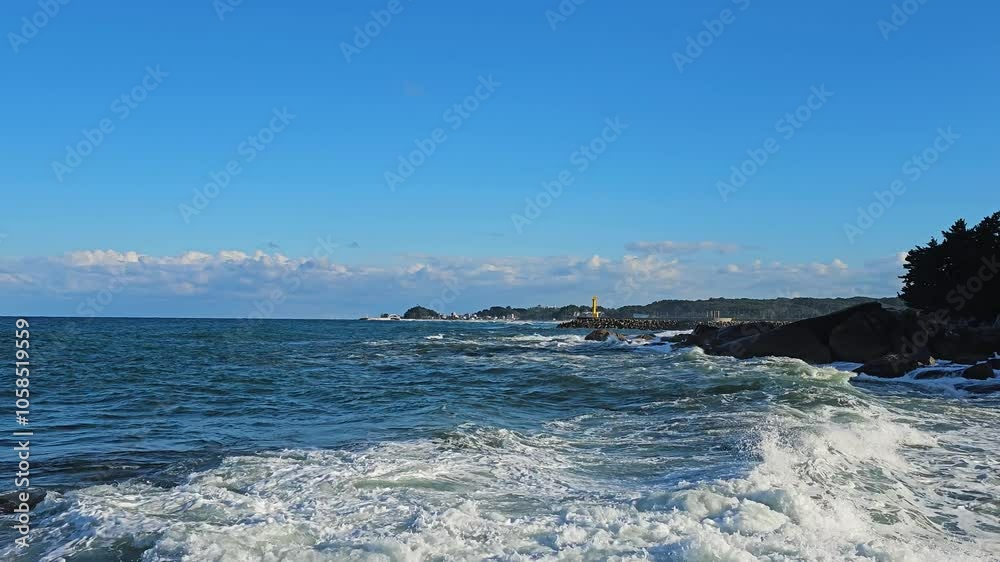 Coastal view of the ocean waves crashing against rocks near Hyuhyuam Hermitage, capturing the rugged beauty of the coastline, panoramic wide angle zoom in Coastal view of the ocean waves crashing against rocks near Hyuhyuam Hermitage, capturing the rugged beauty of the coastline, panoramic wide angle zoom in