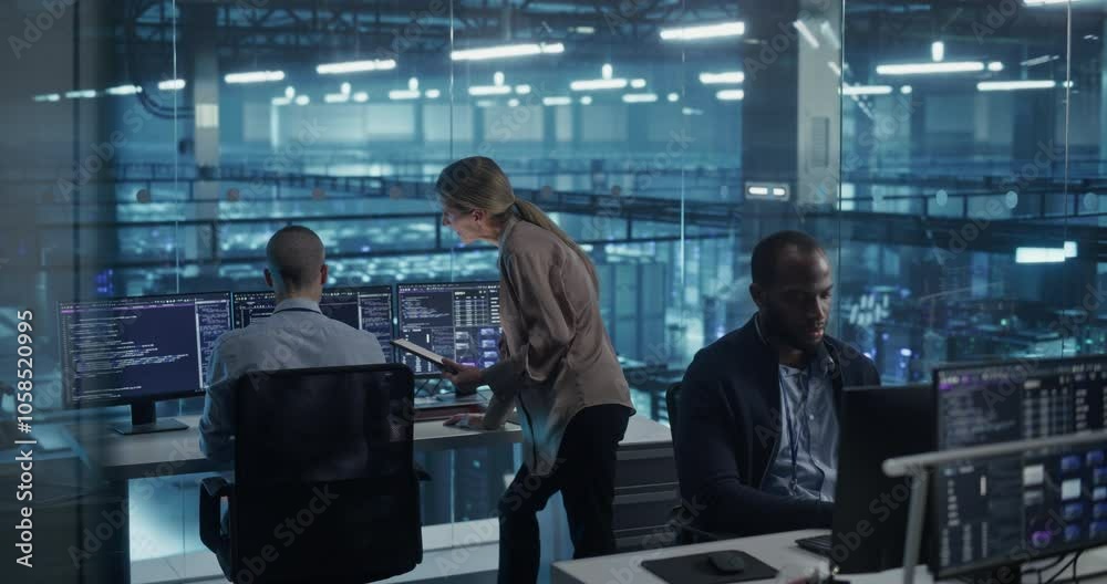 Diverse Team of Developers Working on Computers in a Modern Office in a Data Center Facility. Team Analyzing Data and Optimizing Systems. Female Manager Having a Conversation with a Colleague Diverse Team of Developers Working on Computers in a Modern Office in a Data Center Facility. Team Analyzing Data and Optimizing Systems. Female Manager Having a Conversation with a Colleague