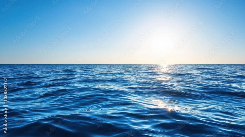 Fototapeta premium A serene ocean view with bright blue water reflecting sunlight under a clear sky, evoking tranquility and natural beauty.