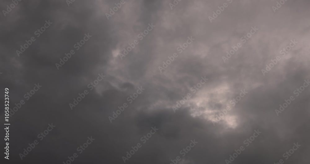 This is a time-lapse video of moving clouds and a dark sky before rain. It shows a beautiful landscape with a cloudy sky. This image was taken in Myanmar with a 4K high-resolution camera.
