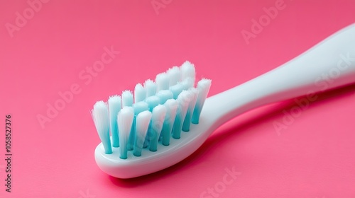 Top view of toothpaste and brush arranged to promote dental hygiene, perfect for creating a radiant smile against a vibrant pink background with ample copy space. photo