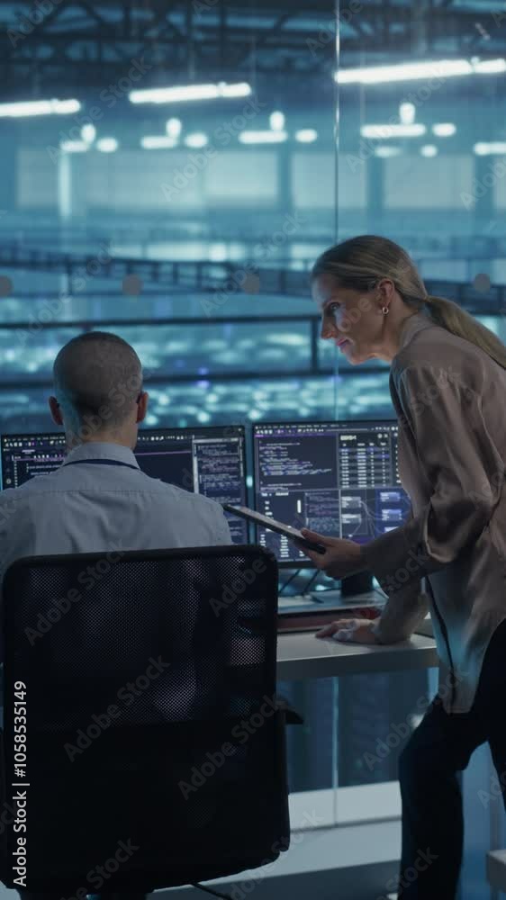 Vertical Screen: Team of Developers Working on Computers in a Modern Office in a Data Center Facility. Team Analyzing Data and Optimizing Systems. Female Manager Having a Conversation with a Colleague Vertical Screen: Team of Developers Working on Computers in a Modern Office in a Data Center Facility. Team Analyzing Data and Optimizing Systems. Female Manager Having a Conversation with a Colleague