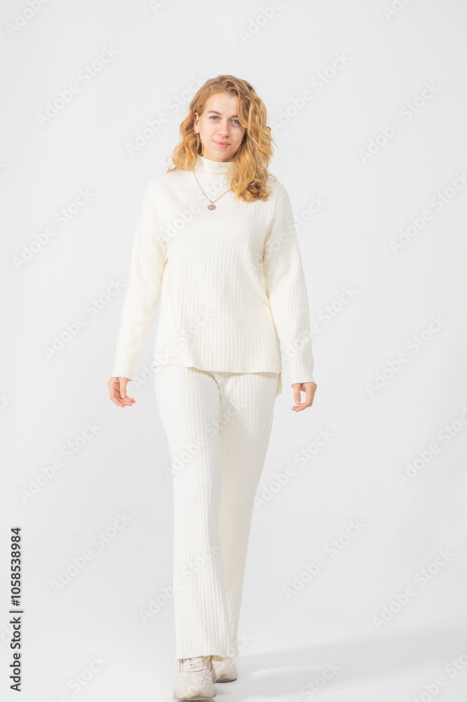 Cute young blonde girl posing standing on white background, copy space Cute young blonde girl posing standing on white background, copy space