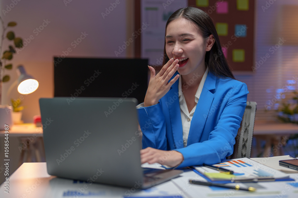 Asian businesswoman, investor showing a happy expression to know the results of financial approval Revenue that has been agreed in the business of real estate projects on a laptop computer in office. Asian businesswoman, investor showing a happy expression to know the results of financial approval Revenue that has been agreed in the business of real estate projects on a laptop computer in office.
