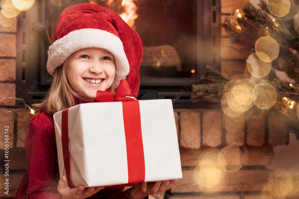 Christmas Kid Having fun with Christmas Gift Box on Christmas Holidays Background. Happy Child Received Gift from Santa at Home near Christmas Tree and Fireplace. Christmas Kid Having fun with Christmas Gift Box on Christmas Holidays Background. Happy Child Received Gift from Santa at Home near Christmas Tree and Fireplace.