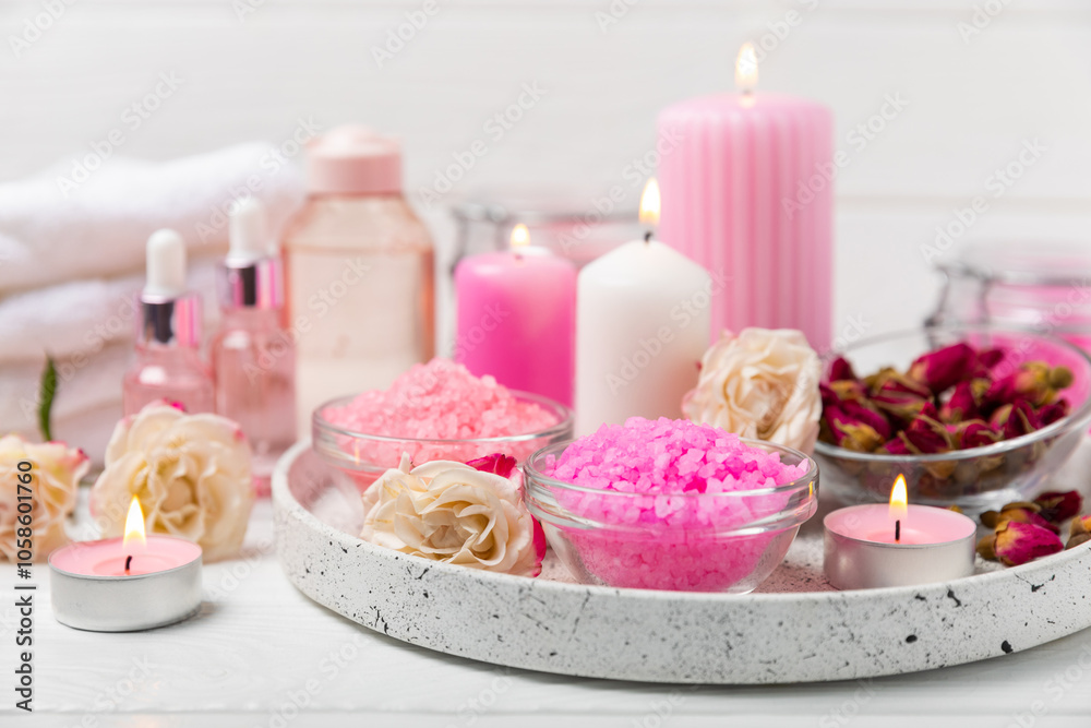 Sea salt for bath with aroma and rose flowers on textured wooden background. Pink sea salt. Spa treatments. Natural salt with herbs and essential oils. skincare concept. Meso for text. Copy space Sea salt for bath with aroma and rose flowers on textured wooden background. Pink sea salt. Spa treatments. Natural salt with herbs and essential oils. skincare concept. Meso for text. Copy space