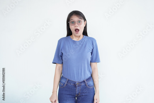 beautiful Asian woman expresses a shoutout, her mouth open wide in excitement against a white background photo