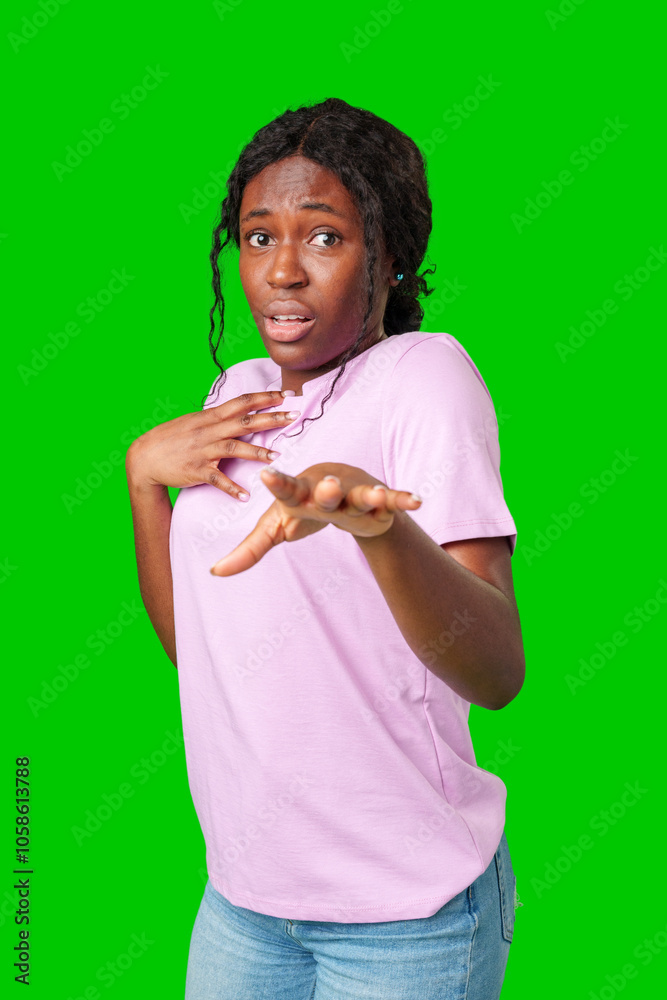Surprised young woman against a vibrant green background expressing astonishment or shock Surprised young woman against a vibrant green background expressing astonishment or shock