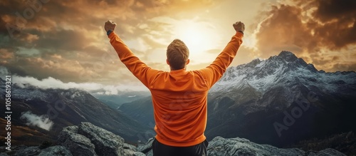 Joyful celebration: man in vibrant orange revels in his success with a scenic mountain view.