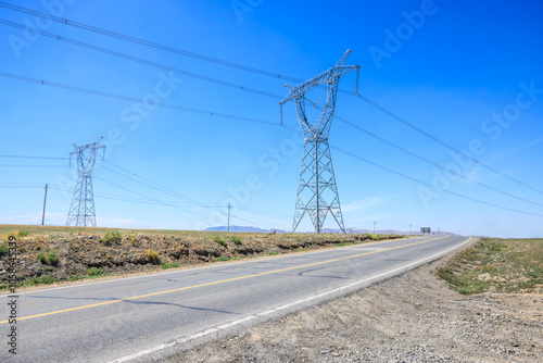 Asphalt highway road and high voltage power tower landscape. road trip.