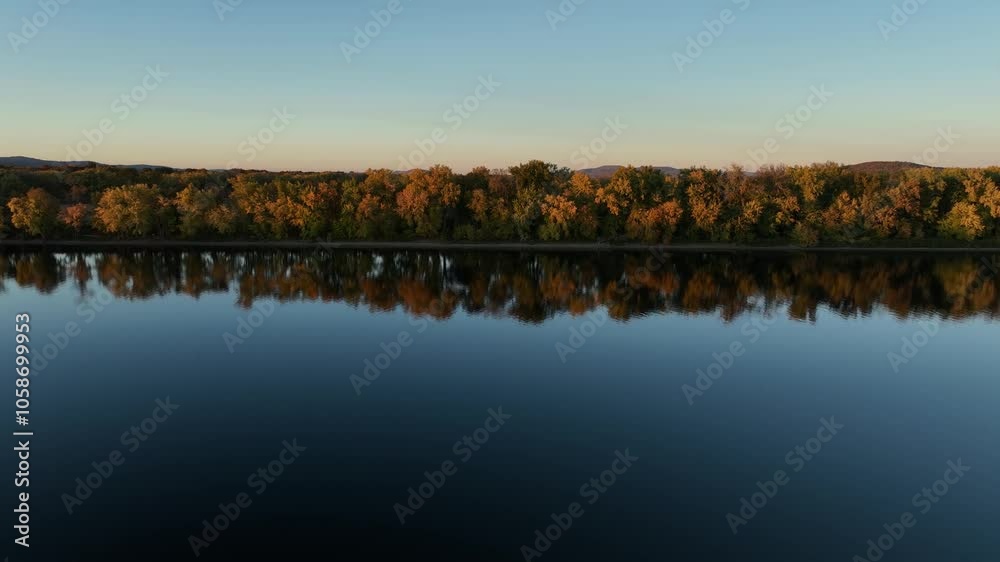 Autumn colors reflect on the calm Connecticut River at sunset near Hadley, Massachusetts Autumn colors reflect on the calm Connecticut River at sunset near Hadley, Massachusetts