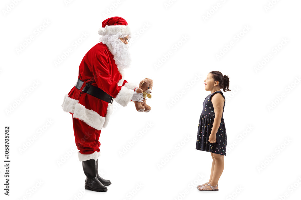 Santa Claus giving a teddy bear to a happy girl Santa Claus giving a teddy bear to a happy girl