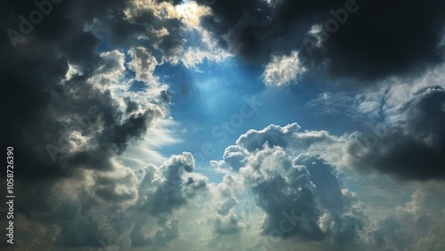 Beautiful cloud landscape, dark clouds are forming a storm, and light is shining down.