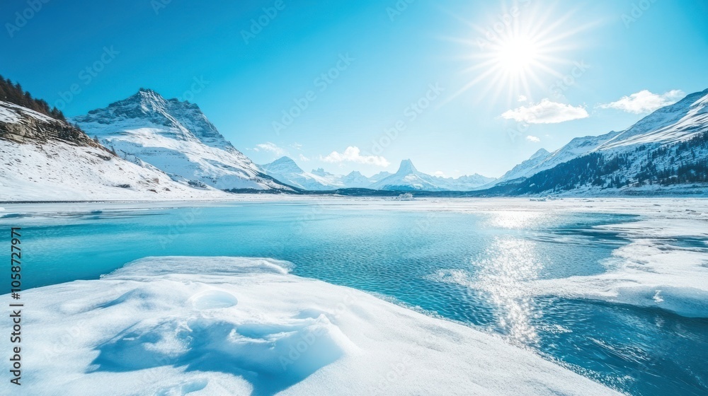 A breathtaking view of a frozen lake with snow-covered mountains in the background. The sun shines brightly, casting a warm glow on the scene. A breathtaking view of a frozen lake with snow-covered mountains in the background. The sun shines brightly, casting a warm glow on the scene.