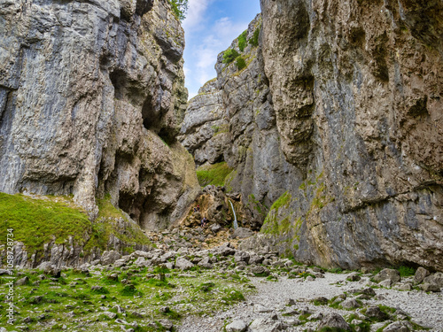 Gordale Scar, a limestone ravine with overhanging limestone cliffs over 330 feet high, Yorkshire Dales National Park, North Yorkshire, UK. This is the far end of the ravine, with it's waterfall. photo