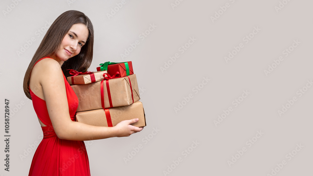 Girl with gifts in hands gray background with space for copying and text Girl with gifts in hands gray background with space for copying and text