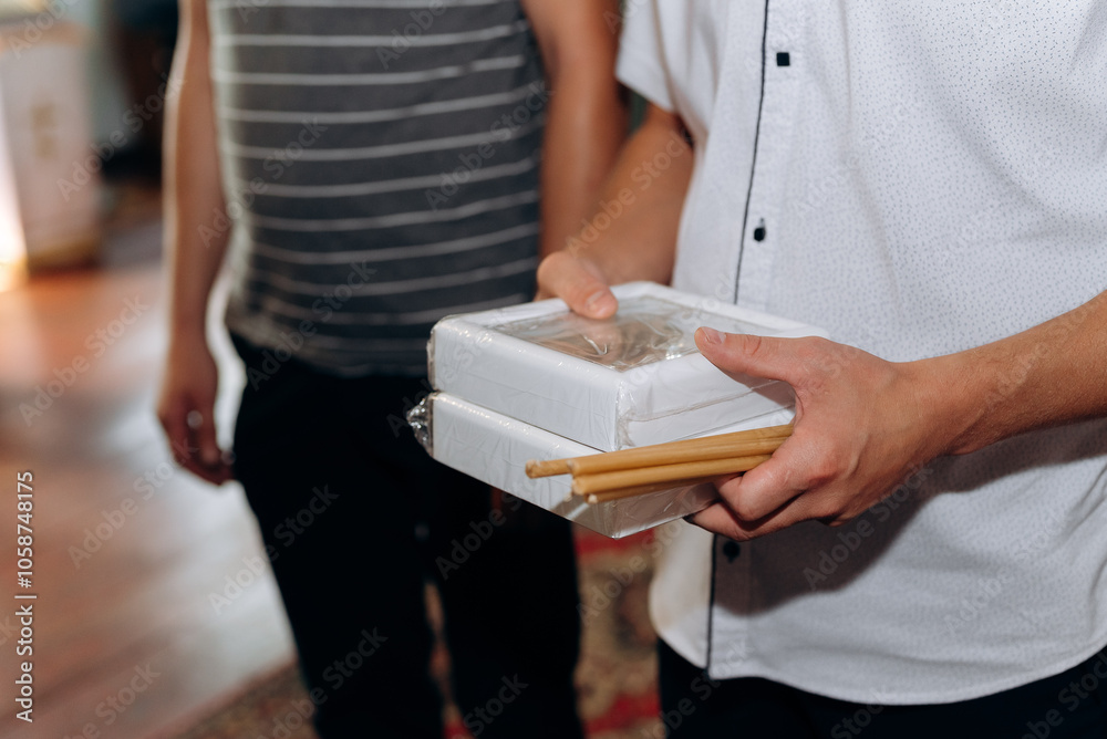 close up of a man holding a gift box