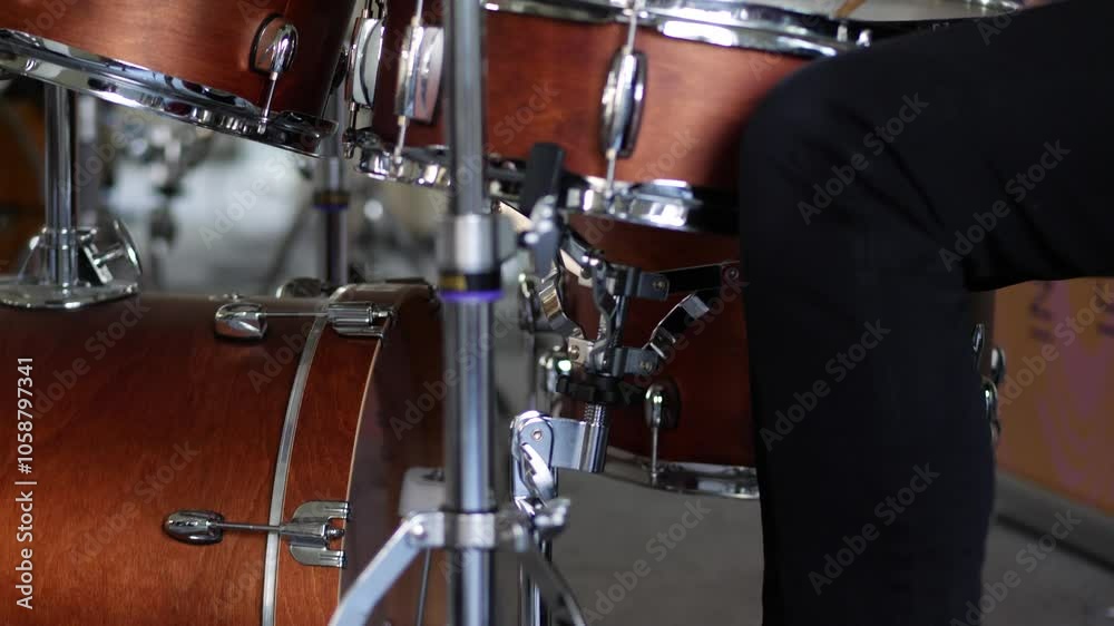 Drummer playing the drums with a downward tilt Drummer playing the drums with a downward tilt