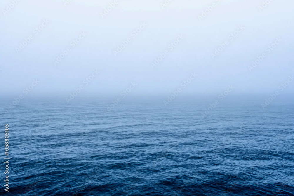 Calm ocean waves under a misty morning sky Calm ocean waves under a misty morning sky