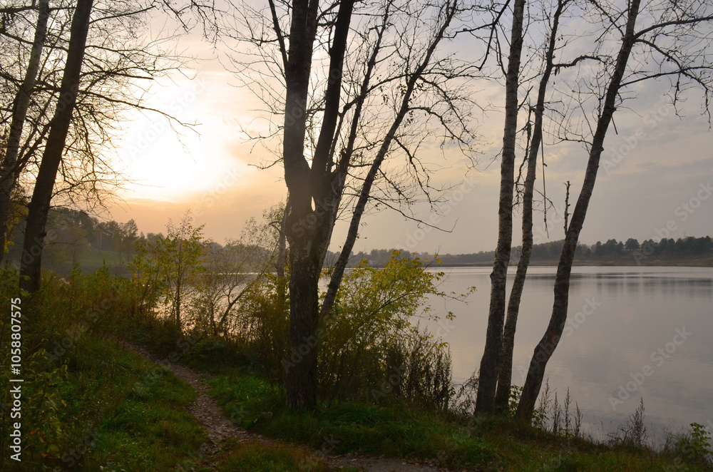 Sunset over the water. Beautiful landscape. The path goes into the distance. Sunset over the water. Beautiful landscape. The path goes into the distance.